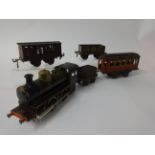 An early 20th century German Bing O gauge 0-4-0 spirit fired locomotive loco and tender, also a