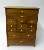 A pine fourteen drawer watchmakers cabinet with bone knobs, height 40cm, width 30cm.