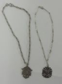 Two silver medallions on chain.