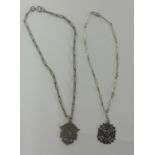 Two silver medallions on chain.