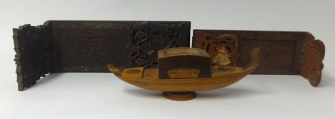 A Black Forest carved oak book slide, another book slide and a musical box formed as a Venetian
