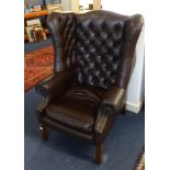 A leather upholstered heavy wing arm chair of Georgian design.