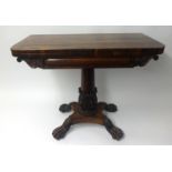 An early Victorian rosewood fold over card table, the pedestal base with carved acanthus leaf column