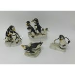 Four Franklin Mint porcelain penguin groups by H.Emblem circa 1980's