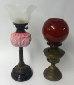 Victorian oil lamp with pink glass embossed reservoir and etched shade together with a brass oil
