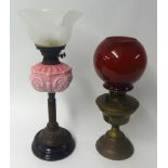 Victorian oil lamp with pink glass embossed reservoir and etched shade together with a brass oil