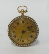 A pretty antique fob watch with gilt dial and roman numerals with key wind hole,