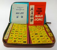 A Mahjong set in leather case and four wood stands.