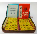 A Mahjong set in leather case and four wood stands.