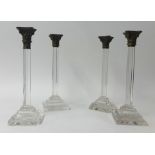 Set four 19th Century, possibly Irish glass candlesticks, each with metal capitals, height 34cm.