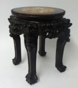 A Chinese carved hardwood jardinière stand, the top inset with marble, height 35cm.