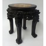 A Chinese carved hardwood jardinière stand, the top inset with marble, height 35cm.