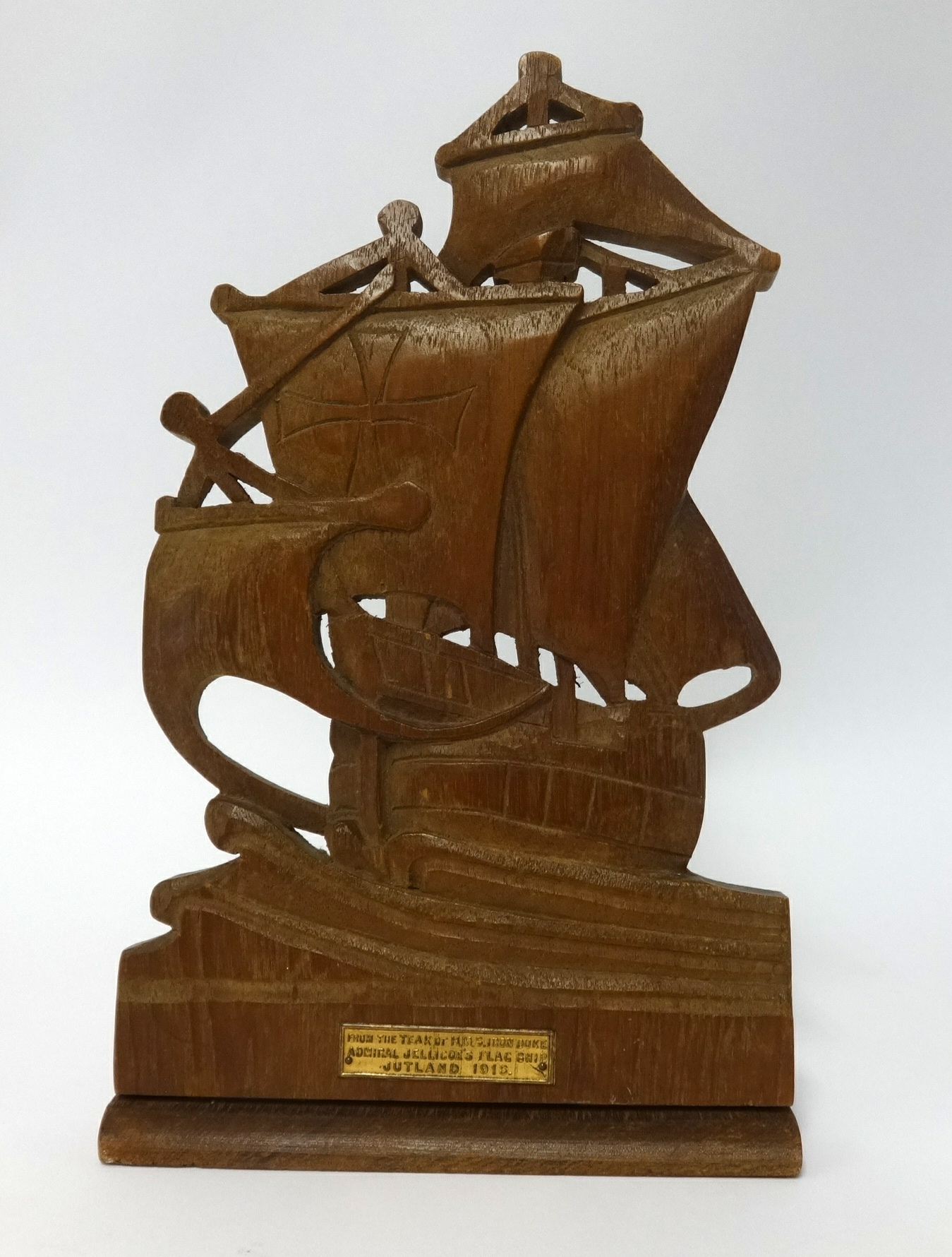 A carved wood bookend with plaque, inscribed 'From the teak of HMS Iron Duke, Admiral Jellicoe's
