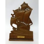 A carved wood bookend with plaque, inscribed 'From the teak of HMS Iron Duke, Admiral Jellicoe's