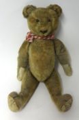Antique teddy bear, with amber glass eyes (damaged), height 40cm, fur loss, broken growler