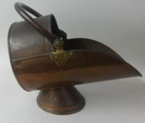 A 19th Century copper coal scuttle together with a pedestal wine table (2).