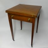 An Edwardian satinwood envelope card table, square rotating top with four leaves above a frieze