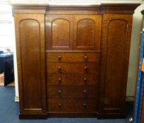 A large and impressive Victorian wardrobe, 'plum pudding' mahogany having a cornice above an