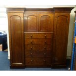 A large and impressive Victorian wardrobe, 'plum pudding' mahogany having a cornice above an