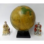 A 20th Century globe together with a pair of modern porcelain figures Henry VIII and Elizabeth I (