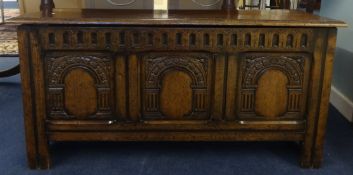 A reproduction 'stressed' oak blanket chest, width 114cm.