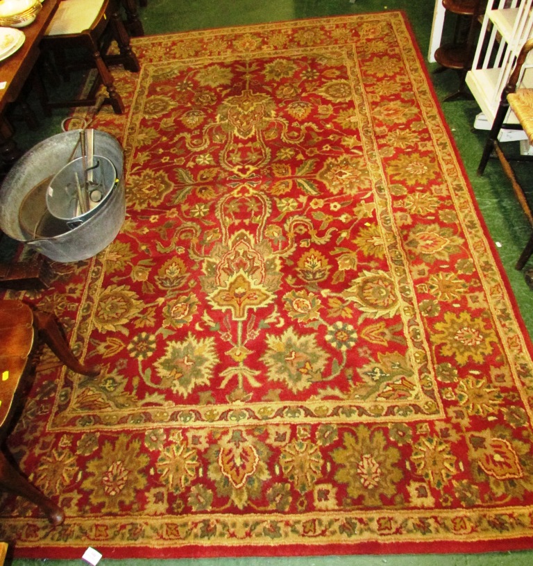 LARGE HAND KNOTTED INDIAN RECTANGULAR RED AND PALE GOLD GROUND FOLIATE PATTERNED FLOOR RUG WITH