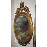 OVAL WALL MIRROR IN DECORATIVE GILT FRAME