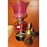 BRASS AND PINK GLASS OIL LAMP ON BLACK LACQUERED BASE AND BRASS MIDDLE EASTERN STYLE TEAPOT