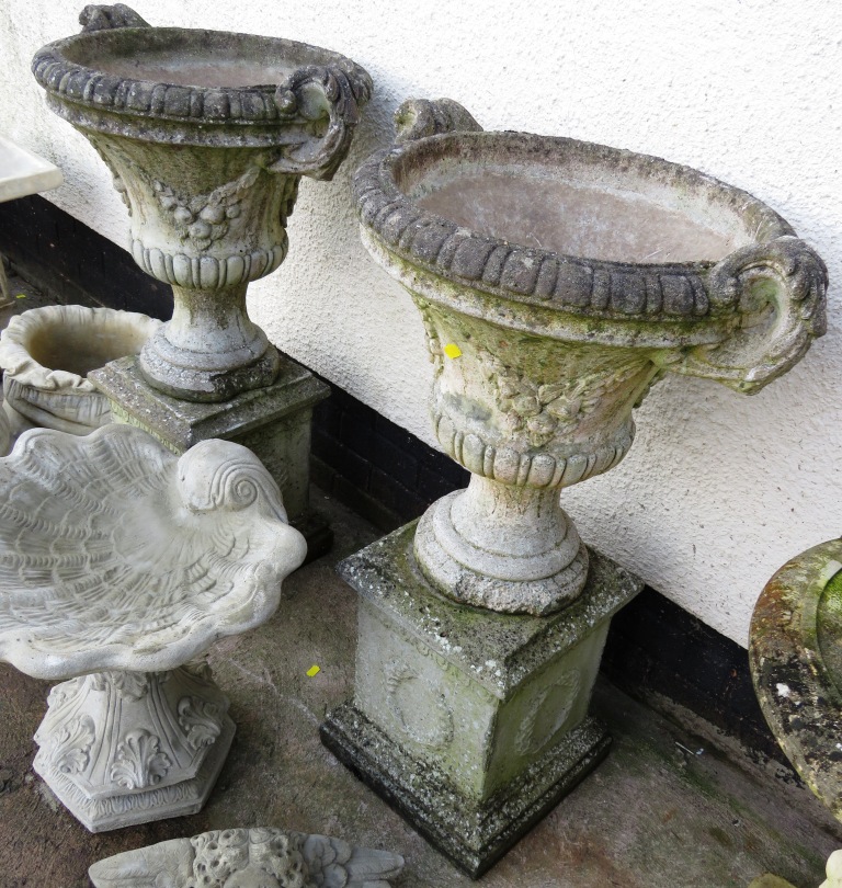 TWO STONEWARE GARDEN URNS ON BASES