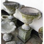 TWO STONEWARE GARDEN URNS ON BASES