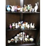 THREE SHELVES OF DECORATIVE CERAMIC AND METAL MINIATURE JUGS