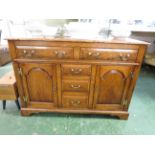 OAK SIDEBOARD WITH TWO DRAWERS OVER TWO CUPBOARD DOORS AND THREE CENTRAL DRAWERS WITH METAL