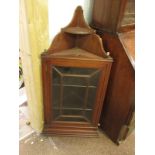 An Edwardian mahogany corner wall cupboard (two shelves within), dentil cornicing and ebony and