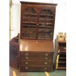 A Victorian mahogany bureau bookcase (possibly a marriage), bureau base has four graduated drawers