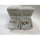 A pair of 9ct gold cultured pearl ear studs with round settings, 3.1g, in a Nottingham and Walsh