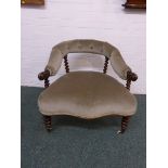 A Victorian upholstered button back tub chair with walnut barley twist supports on white china