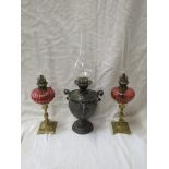 Pair of small brass oil lamps on foliate moulded brass baluster columns on square bases with