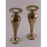 Pair of slender baluster silver vases with filled bases, marks for London, 1912, indistinct maker'