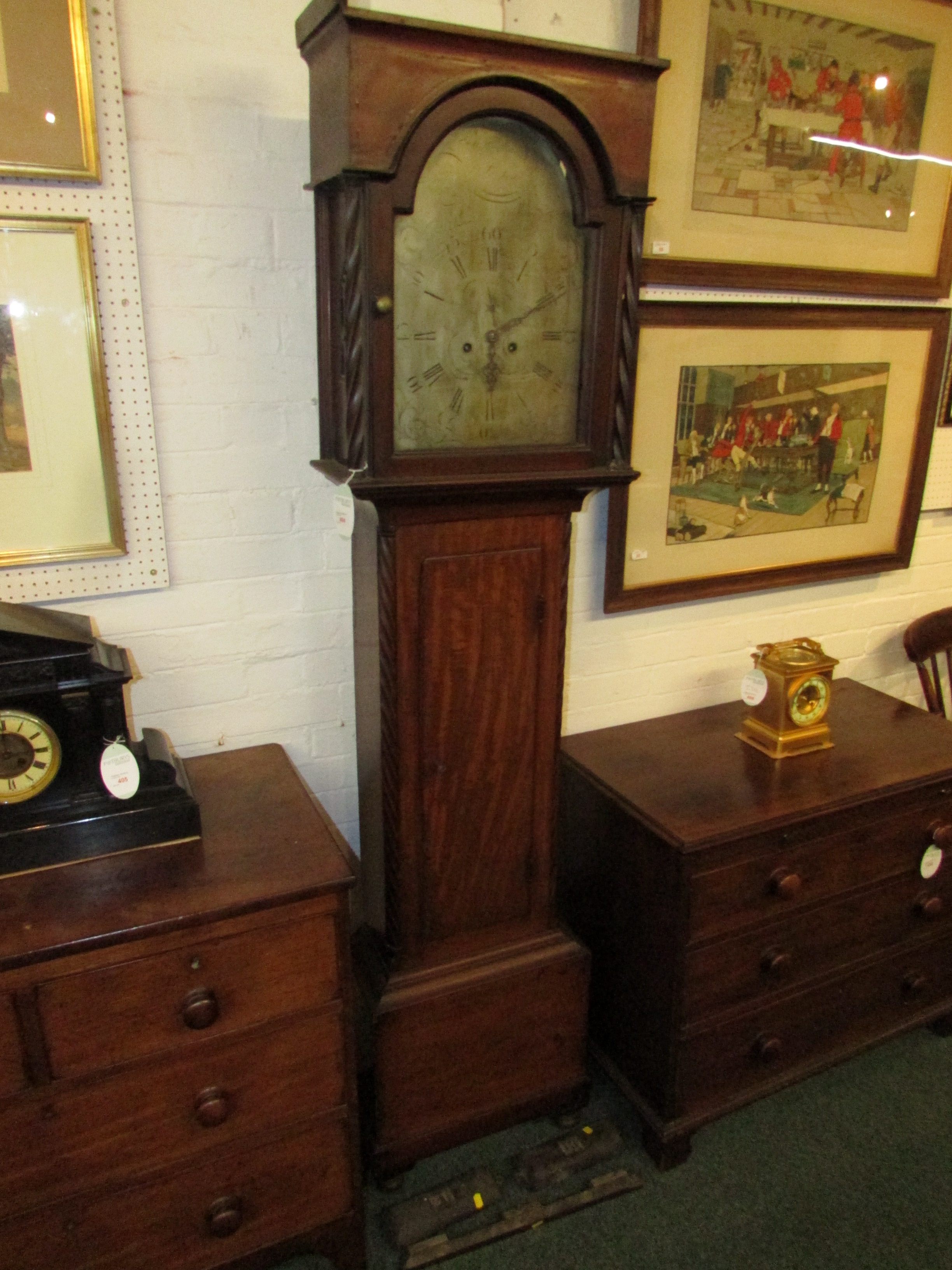 A late 18th century mahogany long case clock with an inlaid square hood, twisted side column