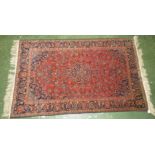 A very finely woven rare Kashan rug in Persian red, navy, and blue colours, in a classical floral