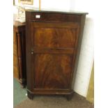 A 19th century single door floor standing corner cupboard. The two panelled door reveals one