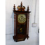 An eight day chiming Edwardian wall clock in a polished red walnut case, the circular brass and