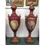 Pair of 20th century floor-standing lidded vases, maroon glazed pottery with gilding, each vase with