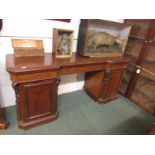 A large Victorian mahogany serving table with long cutlery drawer and two side drawers, with two