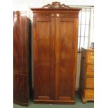 A Victorian mahogany linen press with two plain panel doors enclosing four slides to top and two