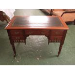 An Edwardian oak ladies writing table with five drawers, tooled green leather scriber, on turned