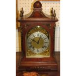 An early 20th century eight day striking mantle clock. The mahogany case has four brass cone finials