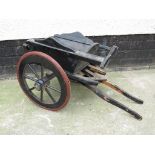 A small wooden two-wheel cart painted black, length 69cm