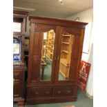 A late Victorian gentleman's double wardrobe, the doors with mirrored, architecturally moulded and