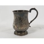 Victorian small silver tankard of baluster shape on a shaped circular foot with scrolled handle, the